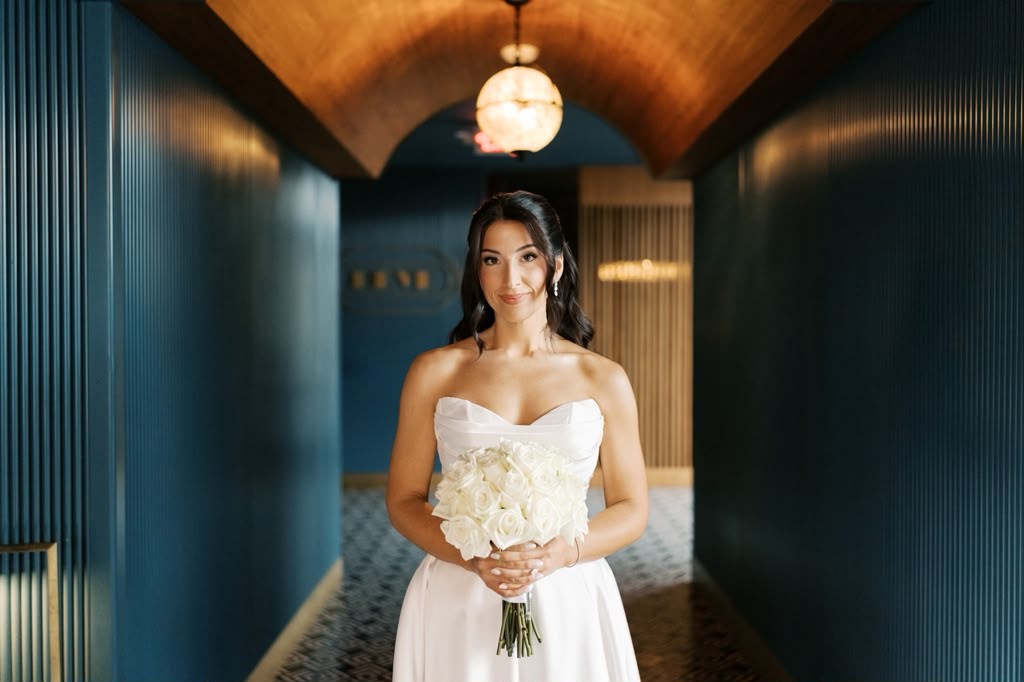 Bride holding her bouquet in an elegant hallway